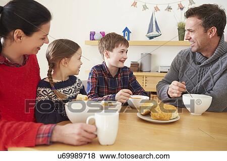 Stock Photo - Family Having A Bowl Of Soup For Lunch. Fotosearch
