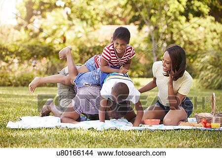 Picture - Family Having Fun In Garden Together. Fotosearch