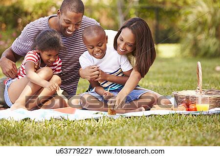 Family Having Picnic In Garden Together View Large Photo Image Stock Photo - Family Having Picnic In Garden Together. Fotosearch