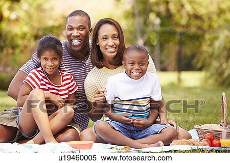 Stock Photography - Family Having Picnic In Garden Together. Fotosearch
