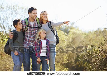 Family Hiking In Countryside Wearing Backpacks View Large Photo Image Stock Photo - Family Hiking In Countryside Wearing Backpacks. Fotosearch