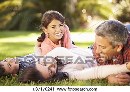 Family Lying On Grass In Countryside View Large Photo Image Stock Image - Family Lying On Grass In Countryside. Fotosearch