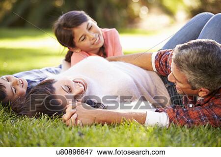 Family Lying On Grass In Countryside View Large Photo Image Stock Photo - Family Lying On Grass In Countryside. Fotosearch