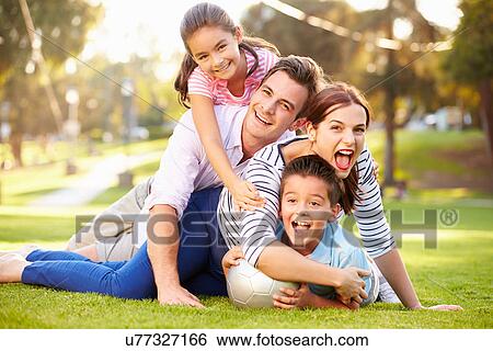 Family Lying On Grass In Park Together View Large Photo Image Stock Photograph - Family Lying On Grass In Park Together. Fotosearch