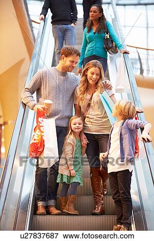 Family On Escalator In Shopping Mall Together View Large Photo Image Stock Photo - Family On Escalator In Shopping Mall Together. Fotosearch