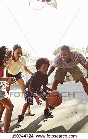 Picture - Family Playing Basketball Game At Home. Fotosearch