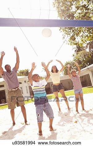 Picture - Family Playing Game Of Volleyball In Garden . Fotosearch
