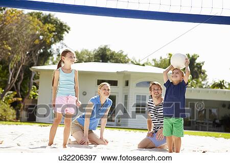 Stock Photo - Family Playing Game Of Volleyball In Garden . Fotosearch