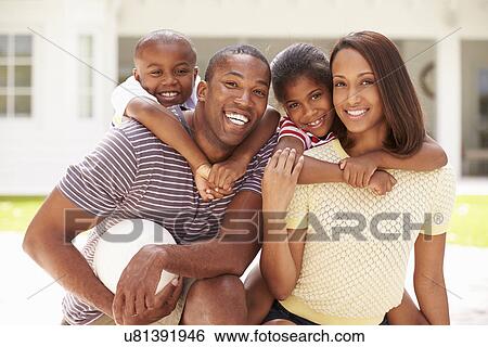 Stock Photograph - Family Playing Game Of Volleyball In Garden . Fotosearch