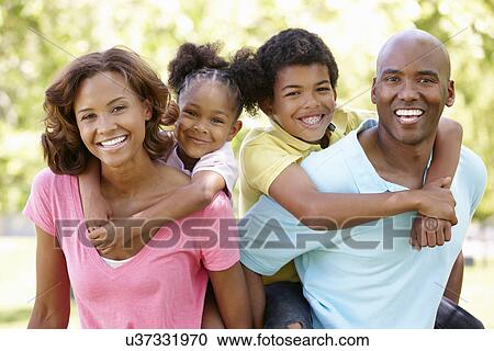 Stock Image - Family portrait in park. Fotosearch