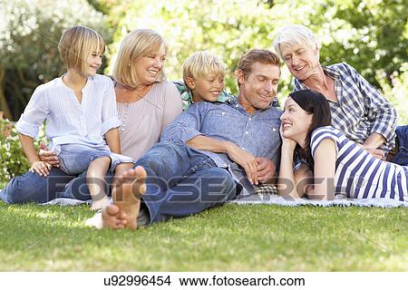 Family relaxing in park View Large Photo Image Picture - Family relaxing in park. Fotosearch