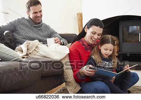 Family Relaxing Indoors And Reading Book View Large Photo Image Stock Photograph - Family Relaxing Indoors And Reading Book. Fotosearch
