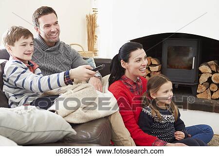 Family Relaxing Indoors Watching Television Together View Large Photo Image Picture - Family Relaxing Indoors Watching Television Together. Fotosearch