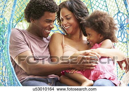 Family Relaxing On Outdoor Garden Swing Seat View Large Photo Image Picture - Family Relaxing On Outdoor Garden Swing Seat. Fotosearch