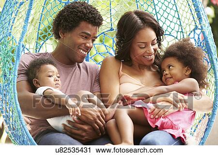 Family Relaxing On Outdoor Garden Swing Seat View Large Photo Image Stock Image - Family Relaxing On Outdoor Garden Swing Seat. Fotosearch