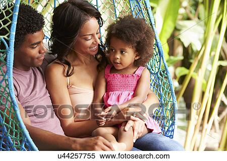 Family Relaxing On Outdoor Garden Swing Seat View Large Photo Image Stock Photography - Family Relaxing On Outdoor Garden Swing Seat. Fotosearch