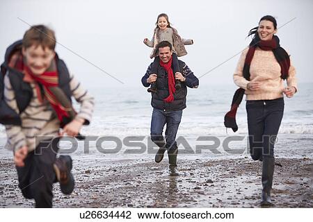 Family Running Along Winter Beach View Large Photo Image Stock Image - Family Running Along Winter Beach. Fotosearch