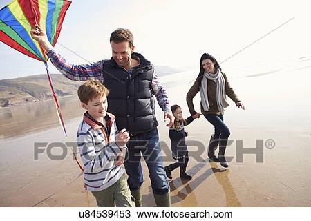 Family Running Along Winter Beach Flying Kite View Large Photo Image Stock Image - Family Running Along Winter Beach Flying Kite. Fotosearch