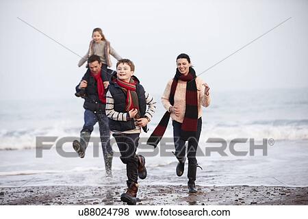 Family Running Along Winter Beach View Large Photo Image Stock Photo - Family Running Along Winter Beach. Fotosearch