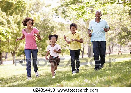 Stock Image - Family running in park. Fotosearch