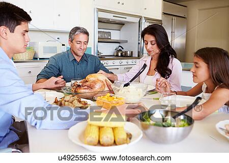 Family Sitting Around Table Saying Prayer Before Eating Meal View Large Photo Image Stock Photography - Family Sitting Around Table Saying Prayer Before Eating Meal. Fotosearch