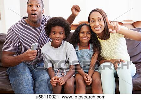 Family Sitting On Sofa Watching TV Together View Large Photo Image Stock Image - Family Sitting On Sofa Watching TV Together. Fotosearch