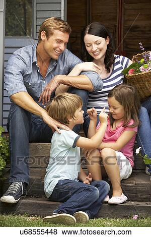 Family sitting on veranda View Large Photo Image Stock Photo - Family sitting on veranda. Fotosearch