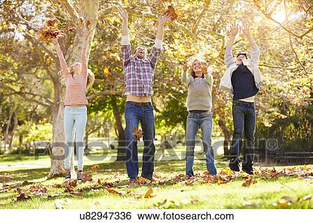 Family Throwing Autumn Leaves In The Air View Large Photo Image Stock Photograph - Family Throwing Autumn Leaves In The Air. Fotosearch