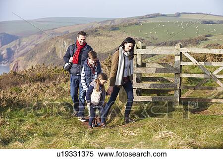 Stock Photography - Family Walking Along Coastal Path. Fotosearch