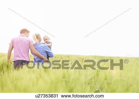 Family Walking In Field Carrying Young Baby Son View Large Photo Image Stock Image - Family Walking In Field Carrying Young Baby Son. Fotosearch
