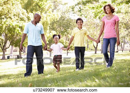 Stock Photo - Family walking in park. Fotosearch