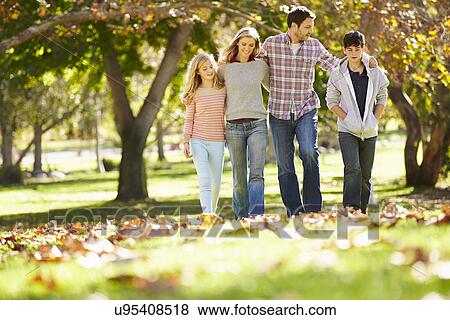 Stock Photo - Family Walking Through Autumn Woodland. Fotosearch