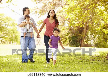 Family With Baby In Carrier Walking Through Park View Large Photo Image Stock Image - Family With Baby In Carrier Walking Through Park. Fotosearch
