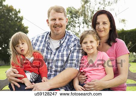 Stock Photo - Family with Downs Syndrome daughter. Fotosearch