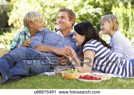 Stock Image - Family with picnic in park. Fotosearch