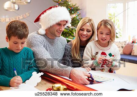 Family Wrapping Christmas Gifts At Home View Large Photo Image Stock Photo - Family Wrapping Christmas Gifts At Home. Fotosearch