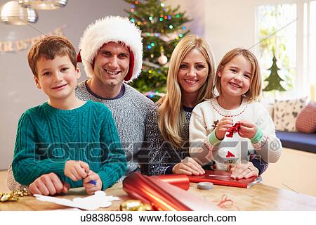 Family Wrapping Christmas Gifts At Home View Large Photo Image Stock Photo - Family Wrapping Christmas Gifts At Home. Fotosearch