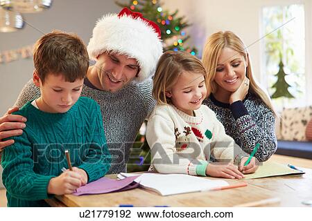 Stock Image - Family Writing Christmas Cards Together. Fotosearch