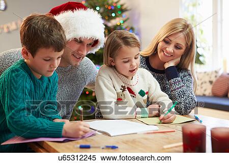 Stock Photography - Family Writing Christmas Cards Together. Fotosearch