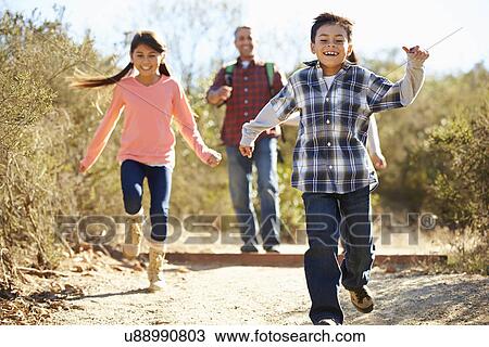 Father And Children Hiking In Countryside Wearing Backpacks View Large Photo Image Stock Image - Father And Children Hiking In Countryside Wearing Backpacks. Fotosearch