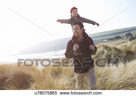 Father And Daughter Walking Through Dunes On Winter Beach View Large Photo Image Stock Photography - Father And Daughter Walking Through Dunes On Winter Beach. Fotosearch