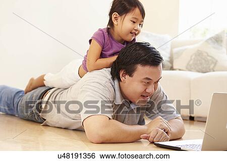 Father And Daughter Watching Movie On Laptop At Home View Large Photo Image Stock Photograph - Father And Daughter Watching Movie On Laptop At Home. Fotosearch