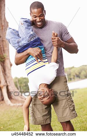 Father And Son Having Fun In Garden Together View Large Photo Image Stock Image - Father And Son Having Fun In Garden Together. Fotosearch