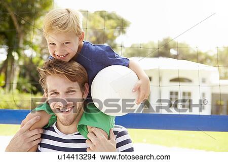 Picture - Father And Son Playing Game Of Volleyball In Garden . Fotosearch