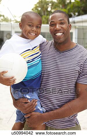 Father And Son Playing Game Of Volleyball In Garden View Large Photo Image Stock Image - Father And Son Playing Game Of Volleyball In Garden . Fotosearch
