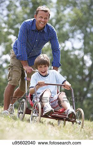 Father and son playing with go-kart View Large Photo Image Stock Image - Father and son playing with go-kart. Fotosearch