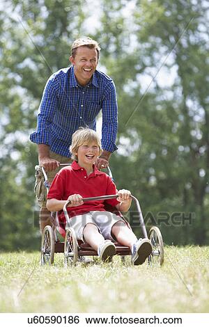 Father and son playing with go-kart View Large Photo Image Stock Photograph - Father and son playing with go-kart. Fotosearch