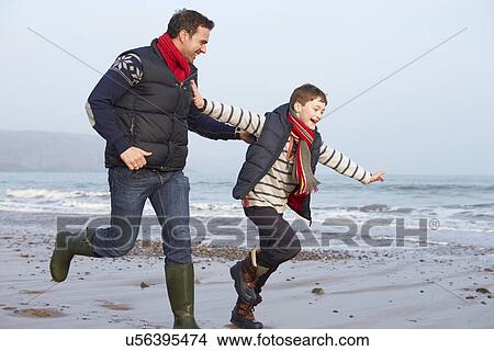 Father And Son Running On Winter Beach View Large Photo Image Picture - Father And Son Running On Winter Beach. Fotosearch