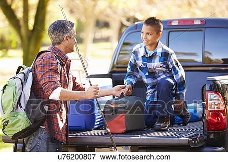 Father And Son Unpacking Truck On Camping Holiday View Large Photo Image Stock Photo - Father And Son Unpacking Truck On Camping Holiday. Fotosearch
