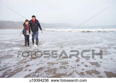 Father And Son Walking On Winter Beach View Large Photo Image Stock Photograph - Father And Son Walking On Winter Beach. Fotosearch